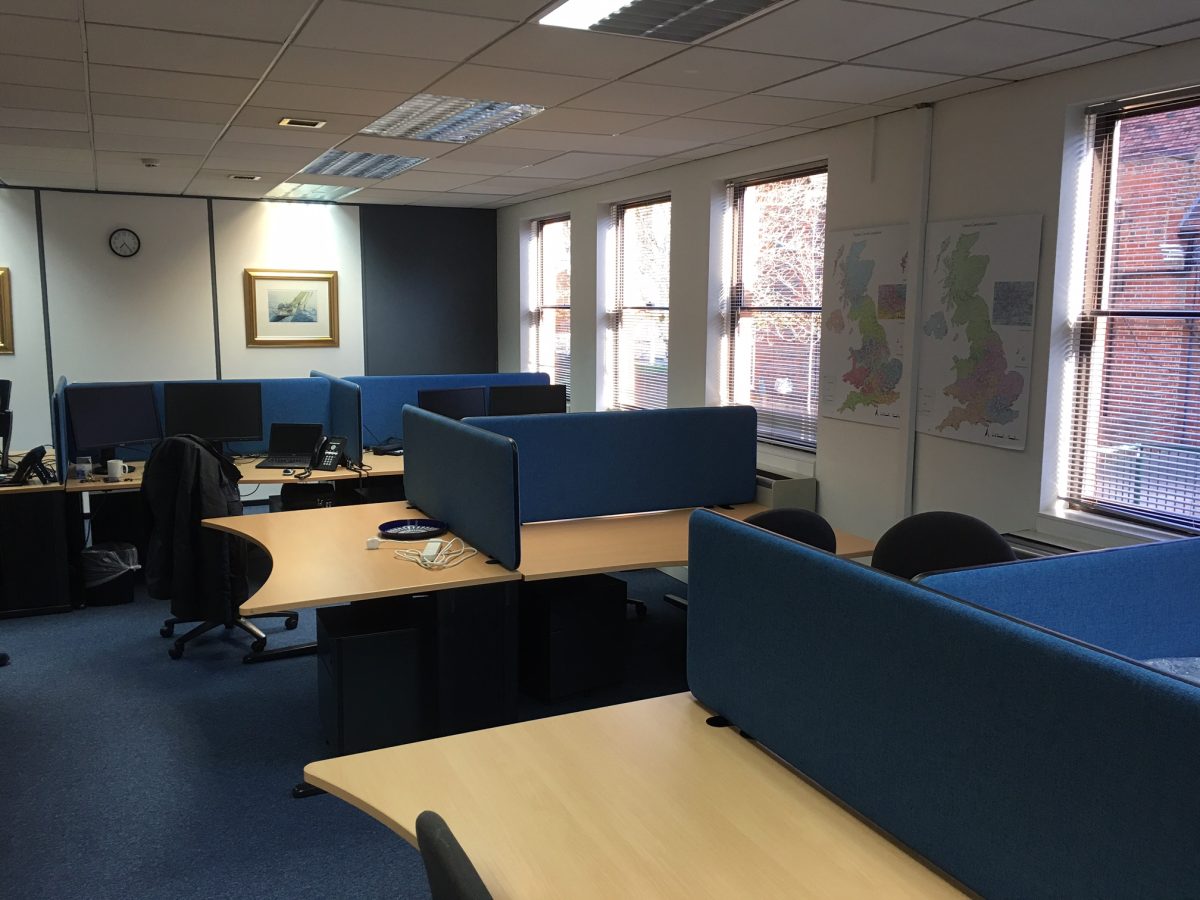 Acoustic desk screens attached to desks