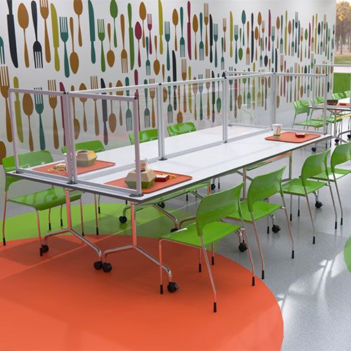 Shield desktop dividers with clear acrylic used to divide a canteen lunch table