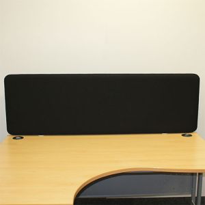 600mm high acoustic delta office desk divider fitted to the back of a desk, complete in black fabric