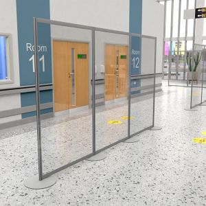 Perspex modular protection screens used in hospital corridor.